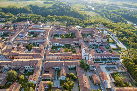 Aerial view of the historic center of Cherasco with its red tiled rooftops ancient churches and green courtyards surrounded by the rolling hills in Cherasco Piedmont Italy. Aerial view of the historic center of Cherasco with its red tiled rooftops ancient churches and green courtyards surrounded by the rolling hills in Cherasco Piedmont Italy.