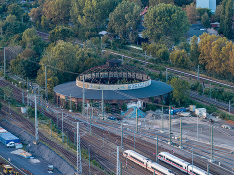Aerial view of the historic roundhouse locomotive shed surrounded by railway tracks and lush trees in Berlin Berlin Germany. Aerial view of the historic roundhouse locomotive shed surrounded by railway tracks and lush trees in Berlin Berlin Germany.
