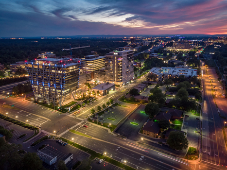 Reston Virginia United States 27 May 2020 Aerial view of modern office buildings and illuminated streets in Reston at dusk featuring a vibrant twilight sky. Reston Virginia United States 27 May 2020 Aerial view of modern office buildings and illuminated streets in Reston at dusk featuring a vibrant twilight sky.