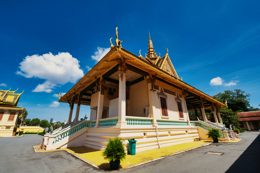 View of the Royal Palace of Cambodia featuring traditional Khmer architecture with ornate golden roofs and intricate details under a clear blue sky in Phnom Penh Phnom Penh Cambodia. View of the Royal Palace of Cambodia featuring traditional Khmer architecture with ornate golden roofs and intricate details under a clear blue sky in Phnom Penh Phnom Penh Cambodia.