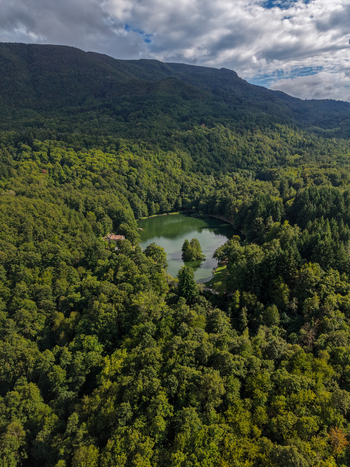 Aerial view of Lago Pontini surrounded by dense forest and mountains in Bagno di Romagna Emilia Romagna Italy. Aerial view of Lago Pontini surrounded by dense forest and mountains in Bagno di Romagna Emilia Romagna Italy.