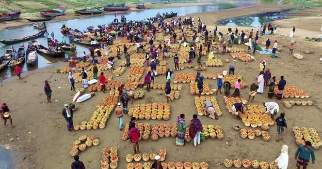 Aerial view of a busy riverside market with boats Bangladesh.
