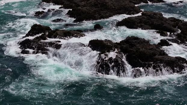 Aerial view of rocky coastline and waves in Fort Bragg United States.