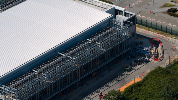 Aerial view of Data facility featuring industrial cooling units on the roof and surrounding infrastructure in Harlow England United Kingdom. Aerial view of Data facility featuring industrial cooling units on the roof and surrounding infrastructure in Harlow England United Kingdom.