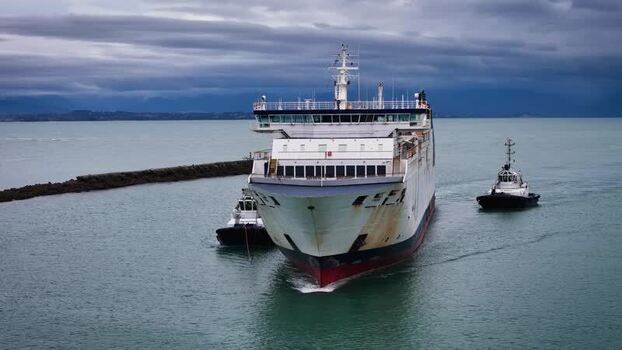 Aerial view of a large ferry escorted by tugboats New Zealand. Aerial view of a large ferry escorted by tugboats New Zealand.