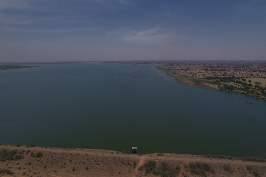 Aerial view of Minjibir dam and the surrounding arid landscape under a clear blue sky in Kano Kano State Nigeria. Aerial view of Minjibir dam and the surrounding arid landscape under a clear blue sky in Kano Kano State Nigeria.