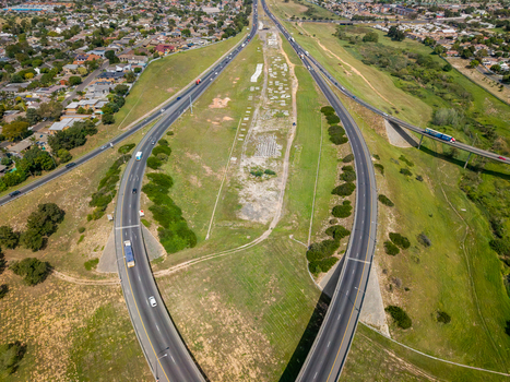 Aerial view of the highway interchange in Brackenfell with surrounding suburban housing and green embankments in Cape Town Western Cape South Africa. Aerial view of the highway interchange in Brackenfell with surrounding suburban housing and green embankments in Cape Town Western Cape South Africa.