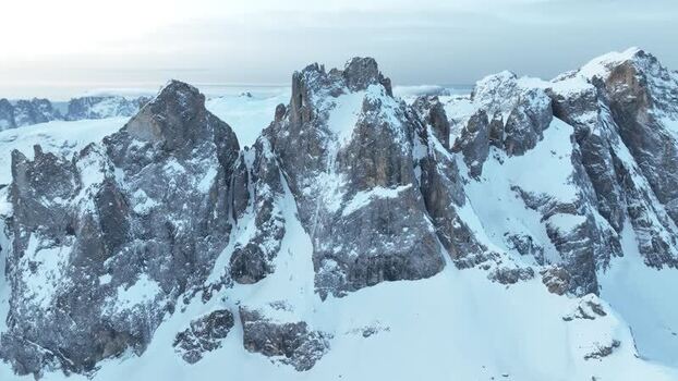 Aerial view of Pale di San Martino peaks in winter Italy.