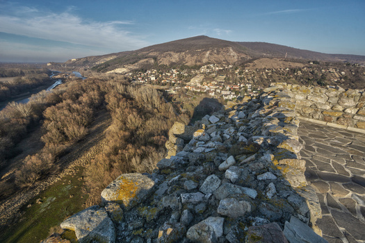 View of Devin Castle stone walls overlooking the Danube and Morava rivers a small village and forested hills under a clear blue sky in Bratislava IV Bratislava Region Slovakia. View of Devin Castle stone walls overlooking the Danube and Morava rivers a small village and forested hills under a clear blue sky in Bratislava IV Bratislava Region Slovakia.