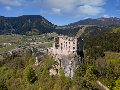 Aerial view of the historic stone ruins of Castle Likava perched on a rocky cliff surrounded by lush green forests and mountains Likavka Zilina Region Slovakia. Aerial view of the historic stone ruins of Castle Likava perched on a rocky cliff surrounded by lush green forests and mountains Likavka Zilina Region Slovakia.