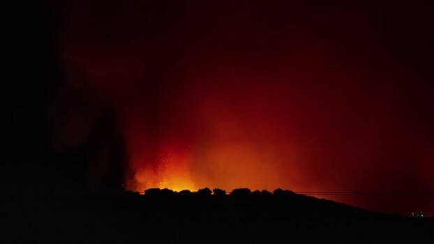 View of a glowing wildfire at night Spain.