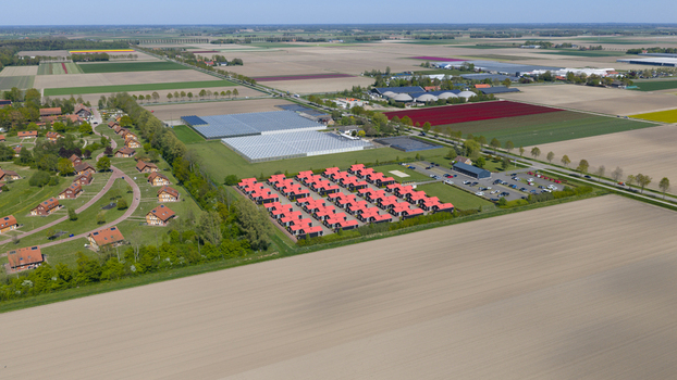 Drone view of AZC Luttelgeest in the Netherlands showing a reception centre for asylum seekers temporary housing community facilities and social infrastructure. Drone view of AZC Luttelgeest in the Netherlands showing a reception centre for asylum seekers temporary housing community facilities and social infrastructure.