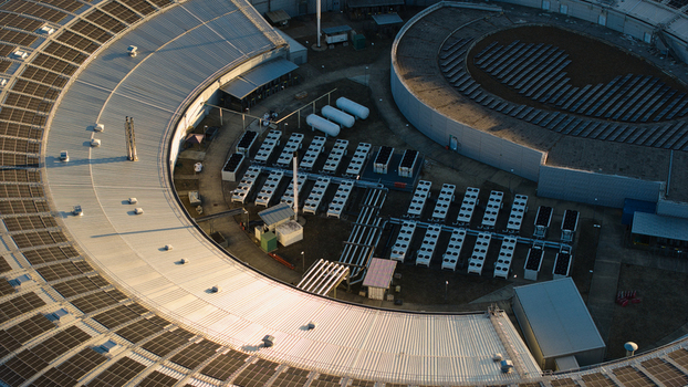 Aerial view of Diamond Light Source a circular synchrotron facility surrounded by greenery under golden hour light in Didcot United Kingdom.