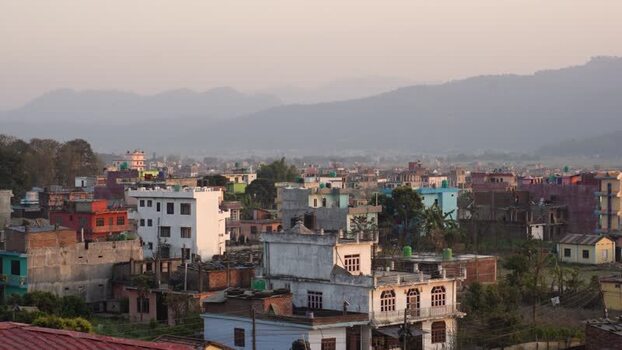 View of colorful urban buildings and misty mountains Nepal.