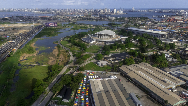 Aerial view of the Wole Soyinka Centre for Culture and Creative Arts National Theatre Nigeria with its unique architecture and the Lagos city skyline in Lagos Lagos Nigeria. Aerial view of the Wole Soyinka Centre for Culture and Creative Arts National Theatre Nigeria with its unique architecture and the Lagos city skyline in Lagos Lagos Nigeria.