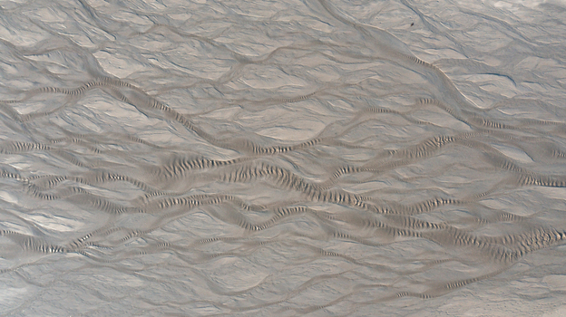 Aerial view of intricate braided sand patterns and ripple textures on the beach at low tide in Mothecombe Devon United Kingdom. Aerial view of intricate braided sand patterns and ripple textures on the beach at low tide in Mothecombe Devon United Kingdom.