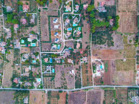 Aerial view of residential houses with swimming pools surrounded by agricultural fields and olive groves in Palermo Sicily Italy. Aerial view of residential houses with swimming pools surrounded by agricultural fields and olive groves in Palermo Sicily Italy.