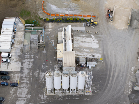 Aerial view of the Holcim concrete plant featuring industrial silos storage areas and vehicles parked on the site Krakow Lesser Poland Voivode Poland.
