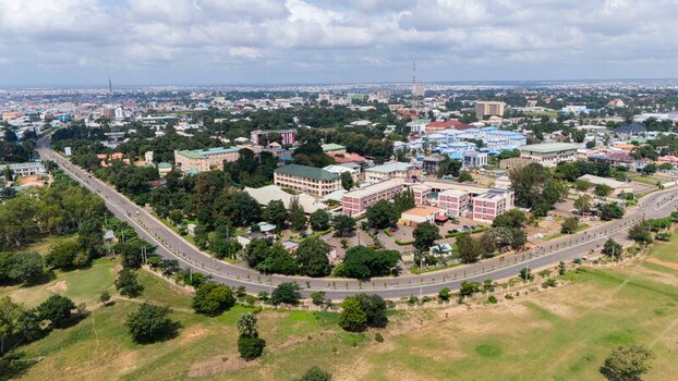 Aerial view of the vibrant city with roads curving through verdant trees and buildings under a vast sky Kaduna Kaduna Nigeria.