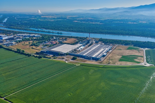 Aerial view of an industrial facility situated near the Grand Canal d Alsace surrounded by vast agricultural fields and green landscapes in Hombourg Grand Est France. Aerial view of an industrial facility situated near the Grand Canal d Alsace surrounded by vast agricultural fields and green landscapes in Hombourg Grand Est France.