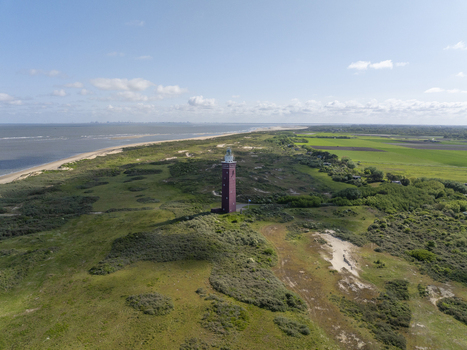 Aerial view of Westhoofd Lighthouse standing amidst the coastal dunes and greenery near the North Sea coastline Ouddorp Zuid Holland Netherlands. Aerial view of Westhoofd Lighthouse standing amidst the coastal dunes and greenery near the North Sea coastline Ouddorp Zuid Holland Netherlands.