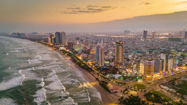 Aerial view of the Da Nang coastline at sunset with modern high rise buildings sandy beach and rolling waves in Da Nang Vietnam. Aerial view of the Da Nang coastline at sunset with modern high rise buildings sandy beach and rolling waves in Da Nang Vietnam.