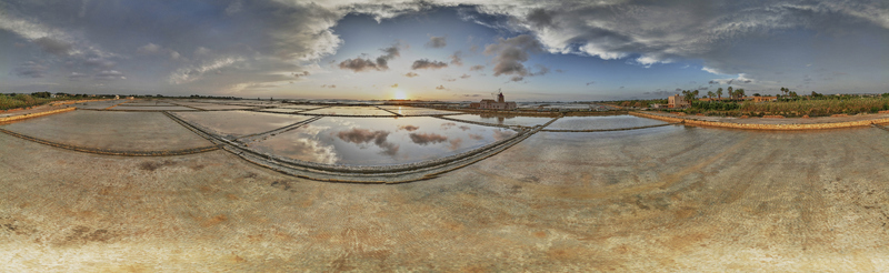 Aerial view of Saline dello Stagnone salt pans at sunset with reflective water pools historic windmills and dramatic clouds in Marsala Sicilia Italy. Aerial view of Saline dello Stagnone salt pans at sunset with reflective water pools historic windmills and dramatic clouds in Marsala Sicilia Italy.