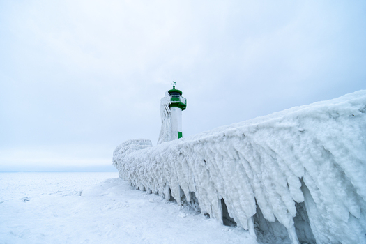View of Molenfeuer Sassnitz covered in thick layers of ice on a frozen pier during a cold winter day in Sassnitz Mecklenburg Vorpommern Germany.
