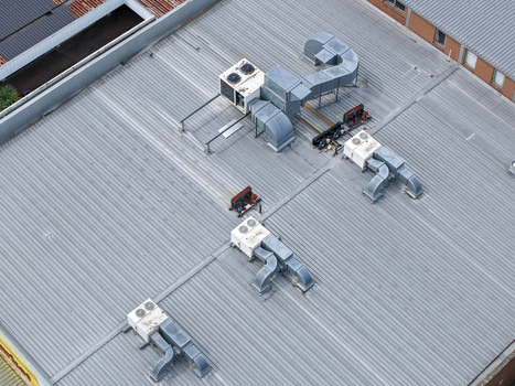 Melbourne VIC Australia 25 September 2026 Aerial view of industrial rooftop with ventilation ducts and HVAC units on a corrugated metal roof.