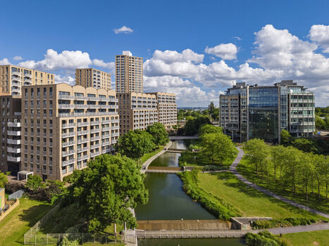 Aerial view of modern apartment buildings and office blocks along the canal at Lakeside Drive in London England United Kingdom. Aerial view of modern apartment buildings and office blocks along the canal at Lakeside Drive in London England United Kingdom.
