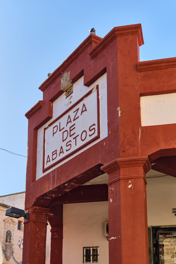 Plasencia Spain 03 December 2025 View of the red facade and sign of the Plaza de Abastos market building under a clear blue sky. Plasencia Spain 03 December 2025 View of the red facade and sign of the Plaza de Abastos market building under a clear blue sky.