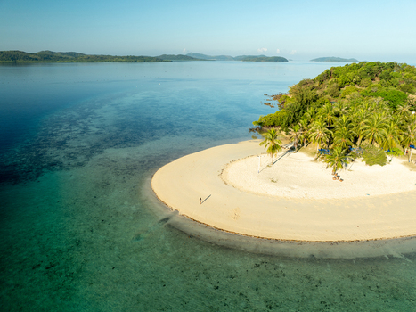Aerial view of Pass Island with its white sand beach lush palm trees and turquoise waters in Coron Philippines. Aerial view of Pass Island with its white sand beach lush palm trees and turquoise waters in Coron Philippines.