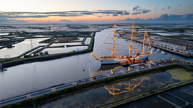 Aerial view of the tall ship NRP Sagres decorated with signal flags navigating the Canal de Aveiro near the salt pans Aveiro Aveiro Portugal. Aerial view of the tall ship NRP Sagres decorated with signal flags navigating the Canal de Aveiro near the salt pans Aveiro Aveiro Portugal.