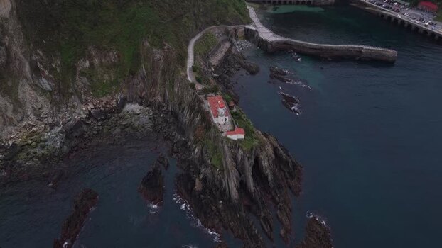 Aerial view of the Faro de Cudillero lighthouse on a rocky cliff Spain. Aerial view of the Faro de Cudillero lighthouse on a rocky cliff Spain.
