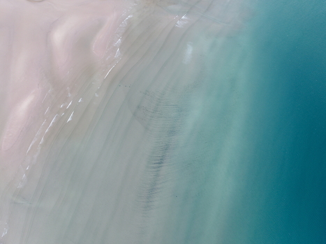 Aerial view of Gruinard Bay with its sandy beach meeting turquoise waters and gentle ripples Gruinard Scotland United Kingdom. Aerial view of Gruinard Bay with its sandy beach meeting turquoise waters and gentle ripples Gruinard Scotland United Kingdom.