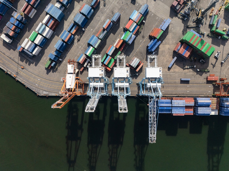 Aerial view of the container terminal in Bajos de Haina featuring gantry cranes colorful shipping containers and port water. Bajos de Haina San Cristobal Province Dominican Republic.