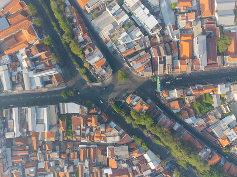 Aerial view of the historic Surabaya old town featuring dense urban architecture terracotta rooftops and intersecting streets in Surabaya East Java Indonesia.