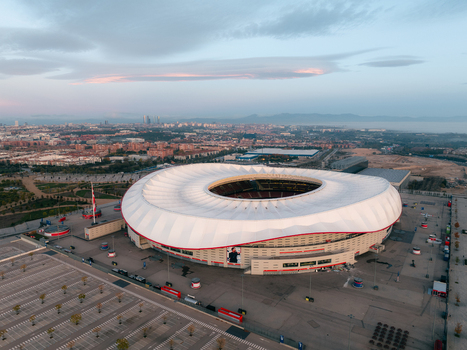 Aerial view of Riyadh Air Metropolitano Stadium with its distinctive white roof and surrounding parking lots in Madrid Comunidad de Madrid Spain.