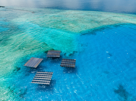 Aerial view of SolarSea floating solar power plant by Swimsol on turquoise waters of a coral reef in Dharavandhoo Baa Atoll Maldives. Aerial view of SolarSea floating solar power plant by Swimsol on turquoise waters of a coral reef in Dharavandhoo Baa Atoll Maldives.