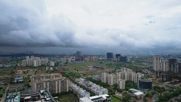 Aerial view of skyscrapers and green fields in Gurugram India.