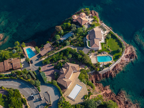 Aerial view of Le Trayas featuring luxury villas with swimming pools lush gardens and rocky coastline overlooking the Mediterranean Sea in Saint Raphael Provence Alpes Cote d Azur France. Aerial view of Le Trayas featuring luxury villas with swimming pools lush gardens and rocky coastline overlooking the Mediterranean Sea in Saint Raphael Provence Alpes Cote d Azur France.