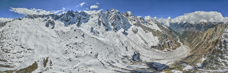 Aerial view of Engadin valley featuring snow covered mountain peaks glaciers and rugged alpine terrain in Grisons Switzerland. Aerial view of Engadin valley featuring snow covered mountain peaks glaciers and rugged alpine terrain in Grisons Switzerland.
