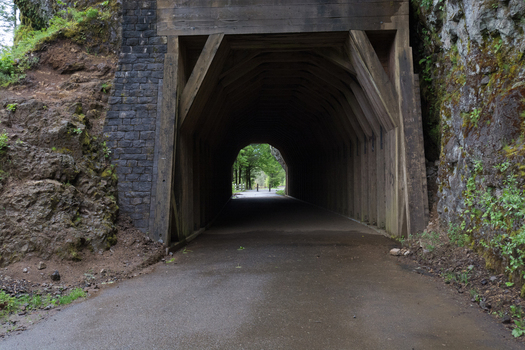 View of the historic wooden tunnel along the Columbia River Highway State Trail in Hood River Oregon United States.
