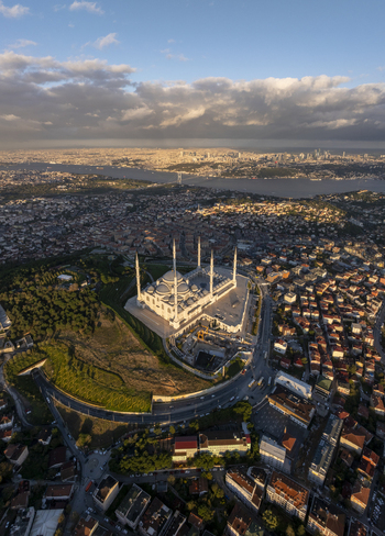 Aerial view of Grand Camlica Mosque surrounded by urban sprawl and greenery during golden hour with the Bosphorus in the background Uskudar Istanbul Turkiye. Aerial view of Grand Camlica Mosque surrounded by urban sprawl and greenery during golden hour with the Bosphorus in the background Uskudar Istanbul Turkiye.
