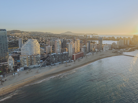 Aerial view of high rise buildings along the sandy beach and Mediterranean Sea in Calp Valencian Community Spain. Aerial view of high rise buildings along the sandy beach and Mediterranean Sea in Calp Valencian Community Spain.
