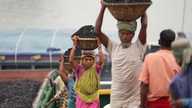 View of workers carrying coal baskets at Aminbazar Bangladesh. View of workers carrying coal baskets at Aminbazar Bangladesh.