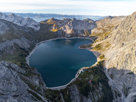 Aerial view of the alpine Lunersee lake surrounded by rugged mountain peaks and rocky terrain in Vandans Vorarlberg Austria. Aerial view of the alpine Lunersee lake surrounded by rugged mountain peaks and rocky terrain in Vandans Vorarlberg Austria.