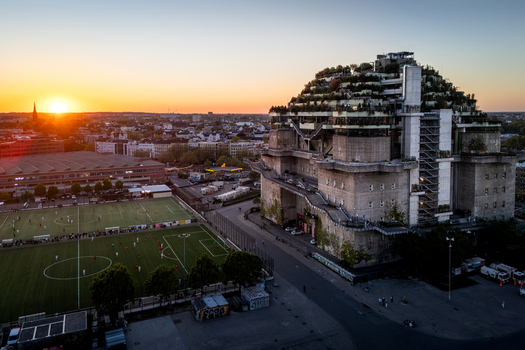 Hamburg Germany 01 May 2026 Aerial view of the green St. Pauli Bunker at Heiligengeistfeld during sunset with a football pitch and the city skyline in the background. Hamburg Germany 01 May 2026 Aerial view of the green St. Pauli Bunker at Heiligengeistfeld during sunset with a football pitch and the city skyline in the background.