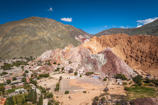 Aerial view of the colorful Cerro de los Siete Colores mountain range overlooking the town of Purmamarca Jujuy Province Argentina. Aerial view of the colorful Cerro de los Siete Colores mountain range overlooking the town of Purmamarca Jujuy Province Argentina.