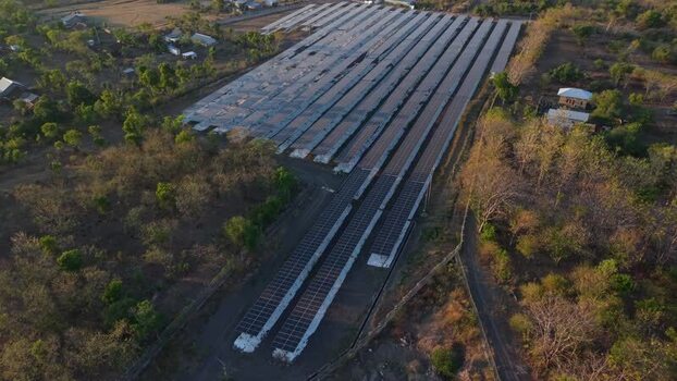 Aerial view of PLTS Bali Timur solar power plant in Indonesia. Aerial view of PLTS Bali Timur solar power plant in Indonesia.